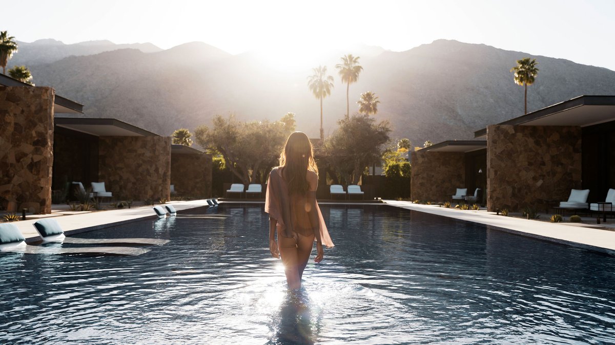 Woman walking into the sunset in a pool